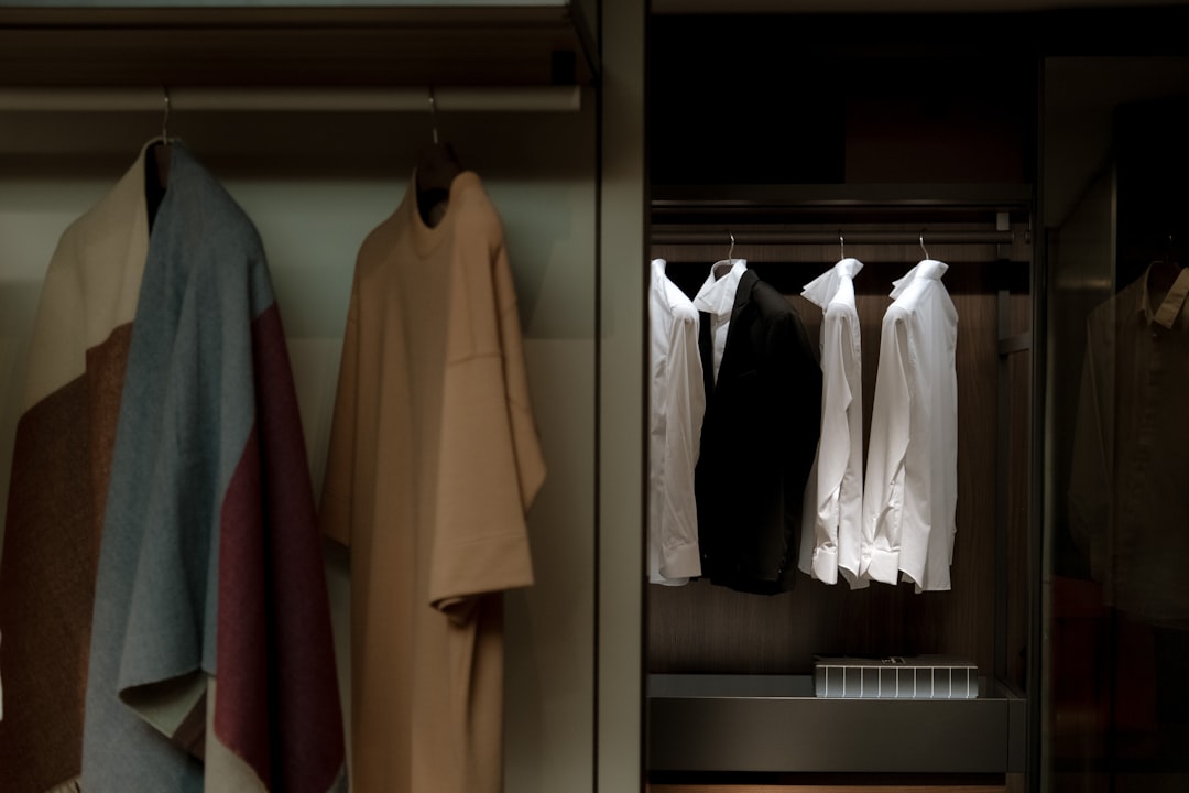 capsule wardrobe for women with coordinated neutral pieces, a tailored blazer, straight-leg trousers, knit tops, and a single accent scarf
